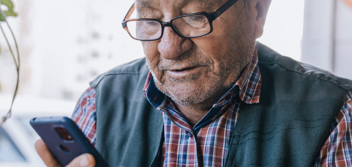 Older man using mobile device.