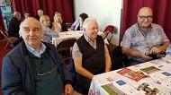 3 men talking at table