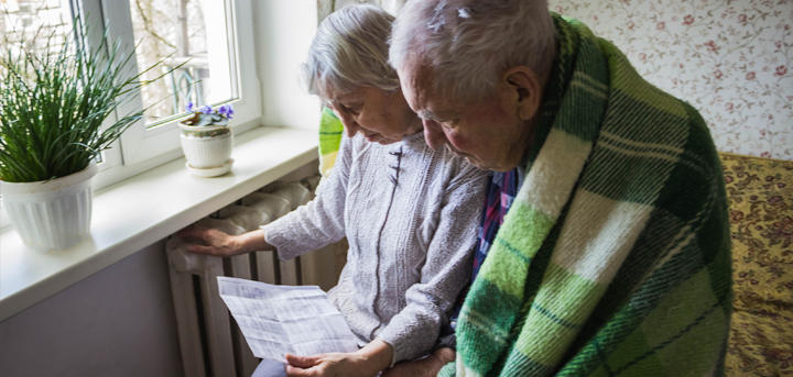 Two older people looking at a bill