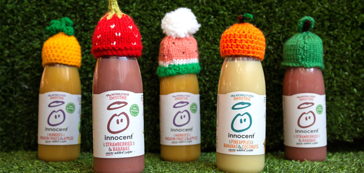 Knitted little hats on innocent smoothie bottles