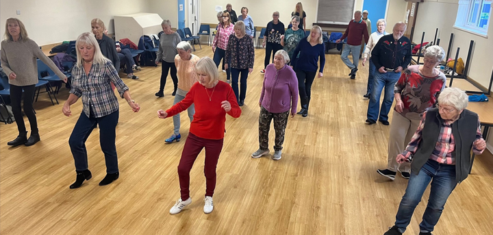 Older people line dancing