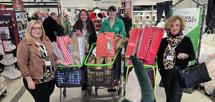 Staff from Age UK Shropshire Telford & Wrekin collecting gifts for local older people from Dunelm Shrewsbury