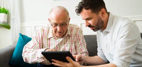 Two men looking at a computer tablet