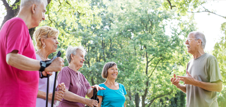 Nordic walking group outside near some trees