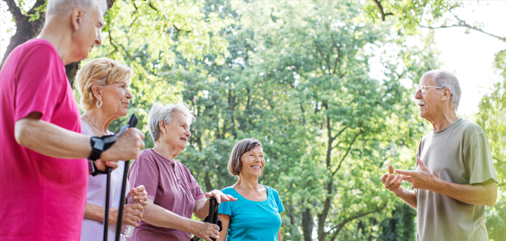 Nordic walking group outside near some trees