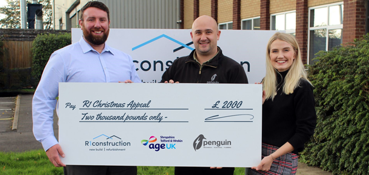 Three people with a large cheque