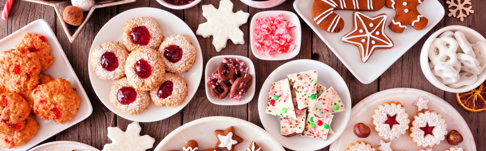 Christmas baked goods like gingerbread and mince pies spread out on a table