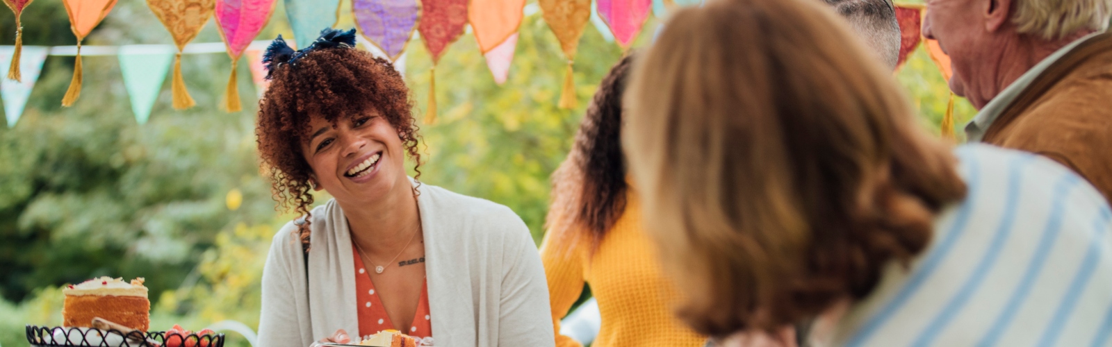 A young woman smiles at a bake sale