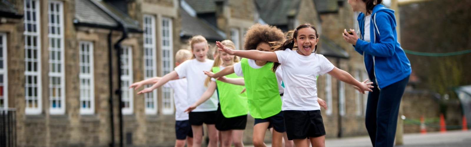 A group of primary school children exercising in a playground