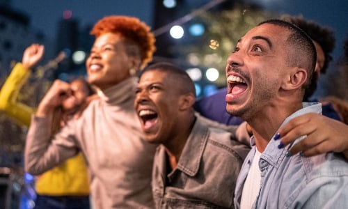 A group of friends celebrate a win