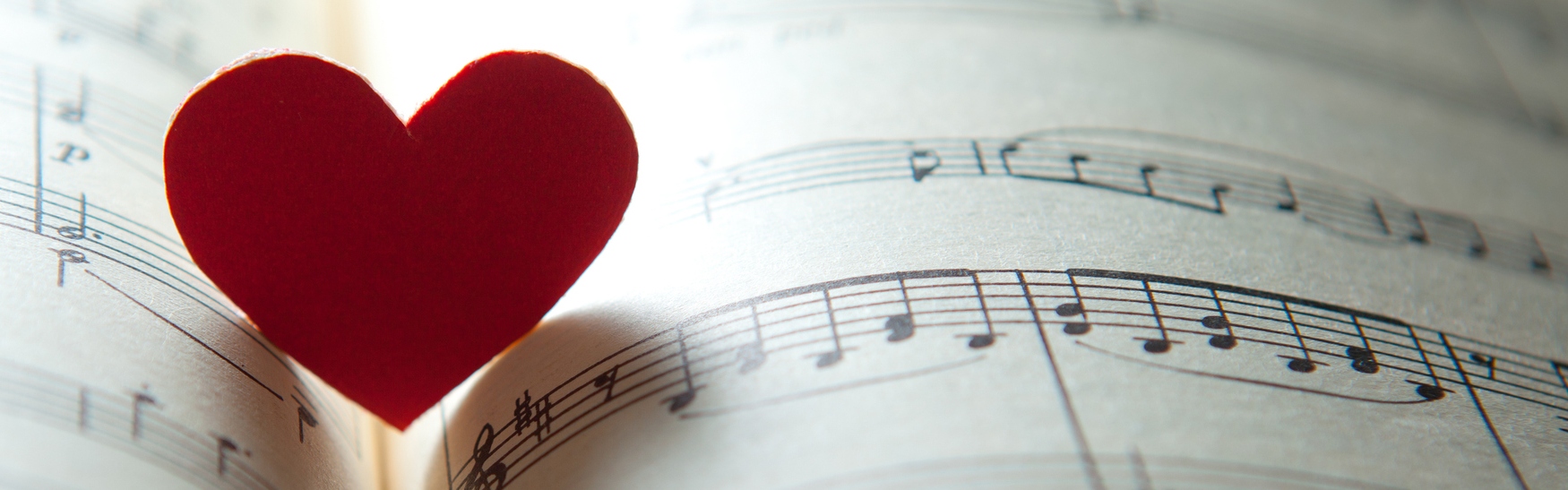 A cut-out heart shape, placed on top of sheet music