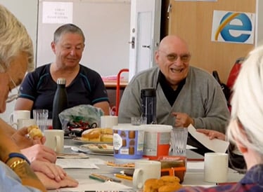 A man and woman laughing together at a table