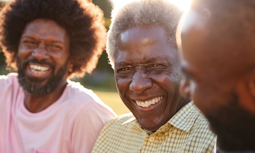 Three men together, smiling