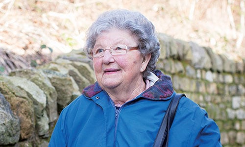 Smiling woman walking outside